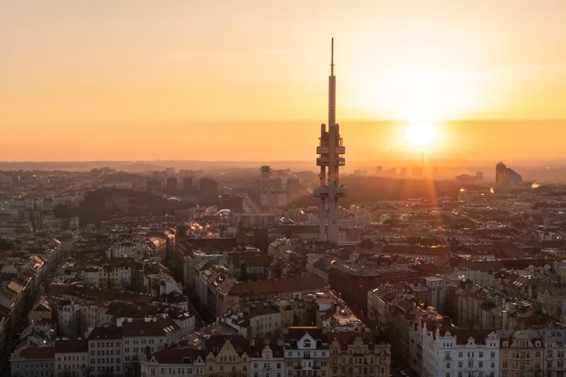 View of Prague at sunset with the Tower Park Prague (Žižkov Tower) standing above the skyline, Czech Republic