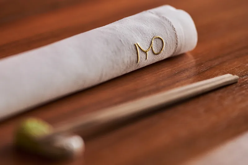 Embroidered napkin and chopsticks of the IYO Restaurant in Milan, Italy