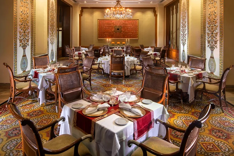 A view of the refined decor and luxury tradition of the Jamavar restaurant tables in Bengaluru, India