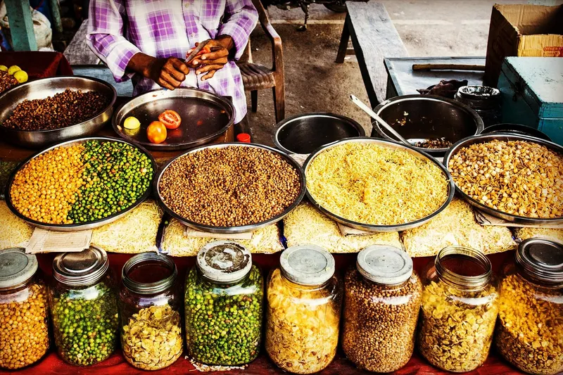 A street vendor in India with a variety of beans and vegetables